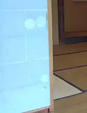 Shoji with three many-petalled flower cutouts in the same paper pasted on; an additional small dent has not yet been patched. All holes are in the hikite (doorpull) area; there is no hikite.