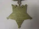 Closeup of star-shaped medal's back side