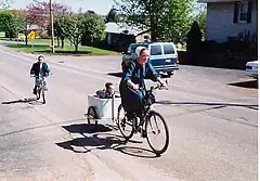 A New Order Amish mother wearing a kapp, going on a shopping trip