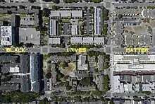 Aerial shot of three city blocks. The words "black," "lives," and "matter" are in all capitol letters, one word on the street per block.