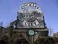 Cockley Cley village sign, showing the church still with its tower