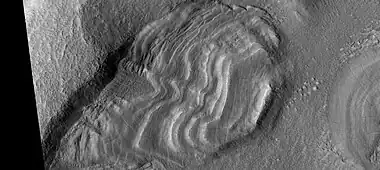 Group of dipping layers.  Each layer represents a change in the Martian climate.