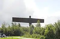 Statue rising above tree line