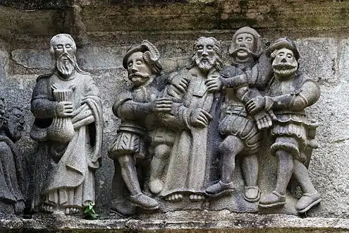Jesus is arrested whilst Judas stands holding the purse.