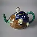 Coloured glazes Oriental Boy on Coconut Teapot and cover c 1870.