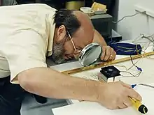 NASA Langley researcher James West looks for signs of water vapor condensation in the encasement of the U.S. Constitution.