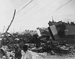 US Navy ship USS LST-476 and USS LST-479 land vehicles and supplies at Roi Island in February 1944