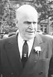 A black-and-white image of a white man in a suit