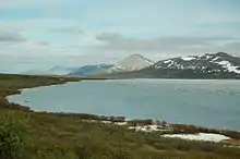 Photograph of the lake with mountains in the background