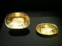 Two Tang  oval lobed gold bowls each with two ducks in repoussé among chased flowers