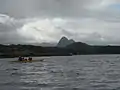 Paddling up Loch Kirkaig Returning to Inverkirkaig in two double sea kayaks, passing close along the north shore of Loch Kirkaig. Suilven lies inland brooding under an overcast sky just starting to clear after a windy morning