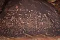 Petroglyphs at Newspaper Rock State Historic Monument carved into desert varnish