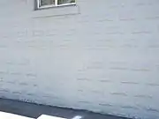 Location of one of the bomb shelter windows of the Charles and Eleanor Abel House which was covered up with cement.