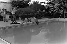 Susan Ford helping her father dive into the new swimming pool