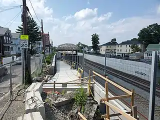 A concrete ramp under construction next to a railway line