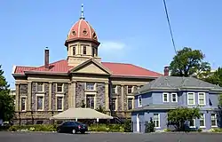 Photograph of a domed church with a smaller two-story house adjacent