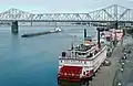 Belle of Louisville at wharf with George Rogers Clark Memorial Bridge in distance, Louisville, Kentucky, USA, Ohio River mile 604, December 1987.
