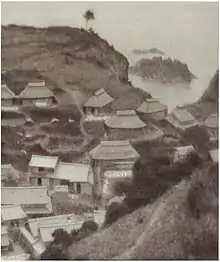 Photograph of the village of Okidomari, extensively retouched to blur detail