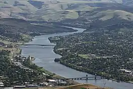 A telephoto view of the Snake River dividing Lewiston, Idaho and Clarkston, Washington. The photographer is atop Lewiston Hill, looking south.  The Interstate Highway Bridge is the closer of the two bridges. The Southway Bridge is in the distance.