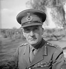 Black and white photographic portrait of man in military uniform.