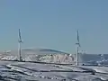 Two of the Hameldon Hill Wind Farm turbines in the winter of 2008.